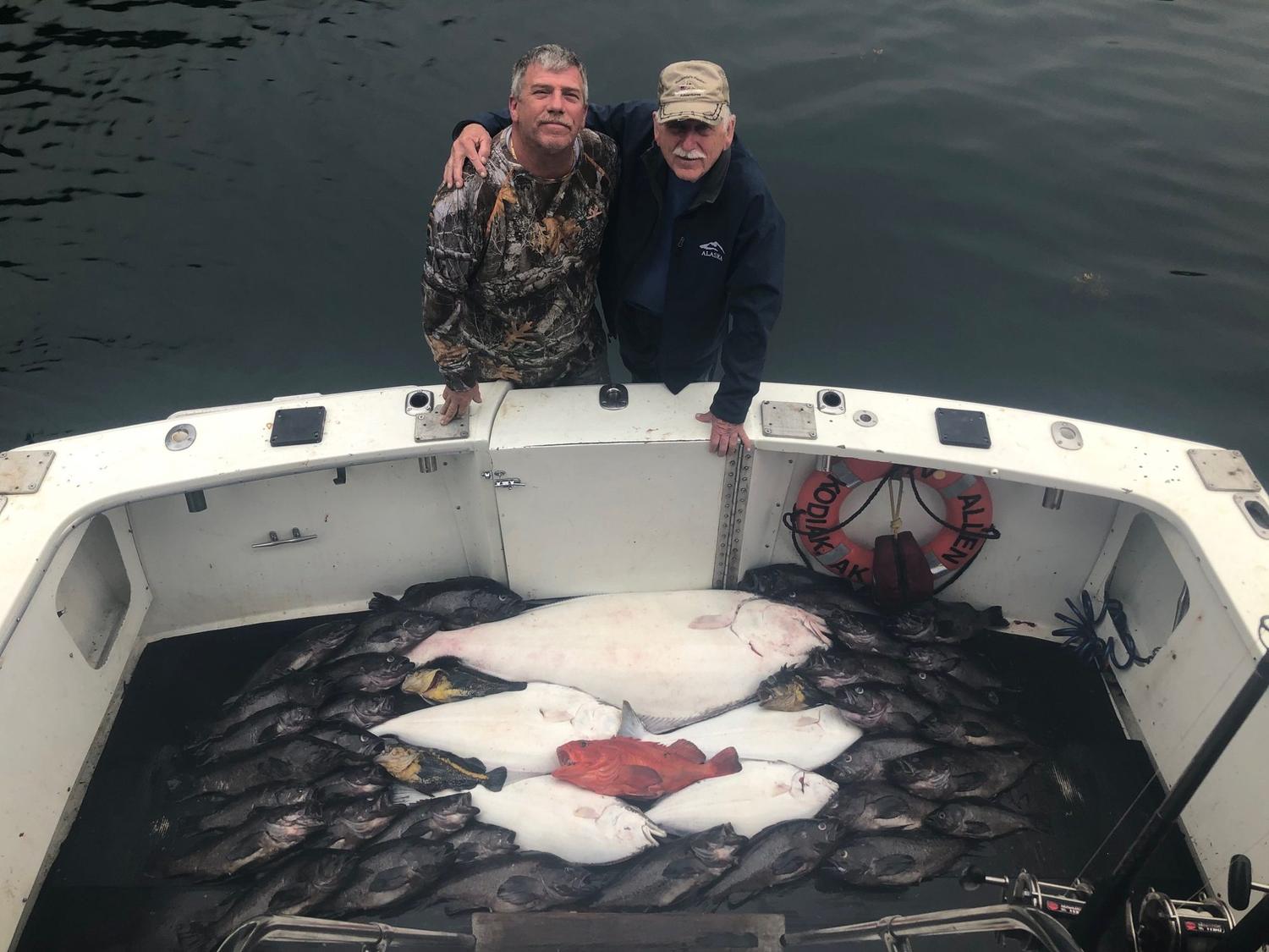 Guests with a deck of halibut aboard Swoboda Charters