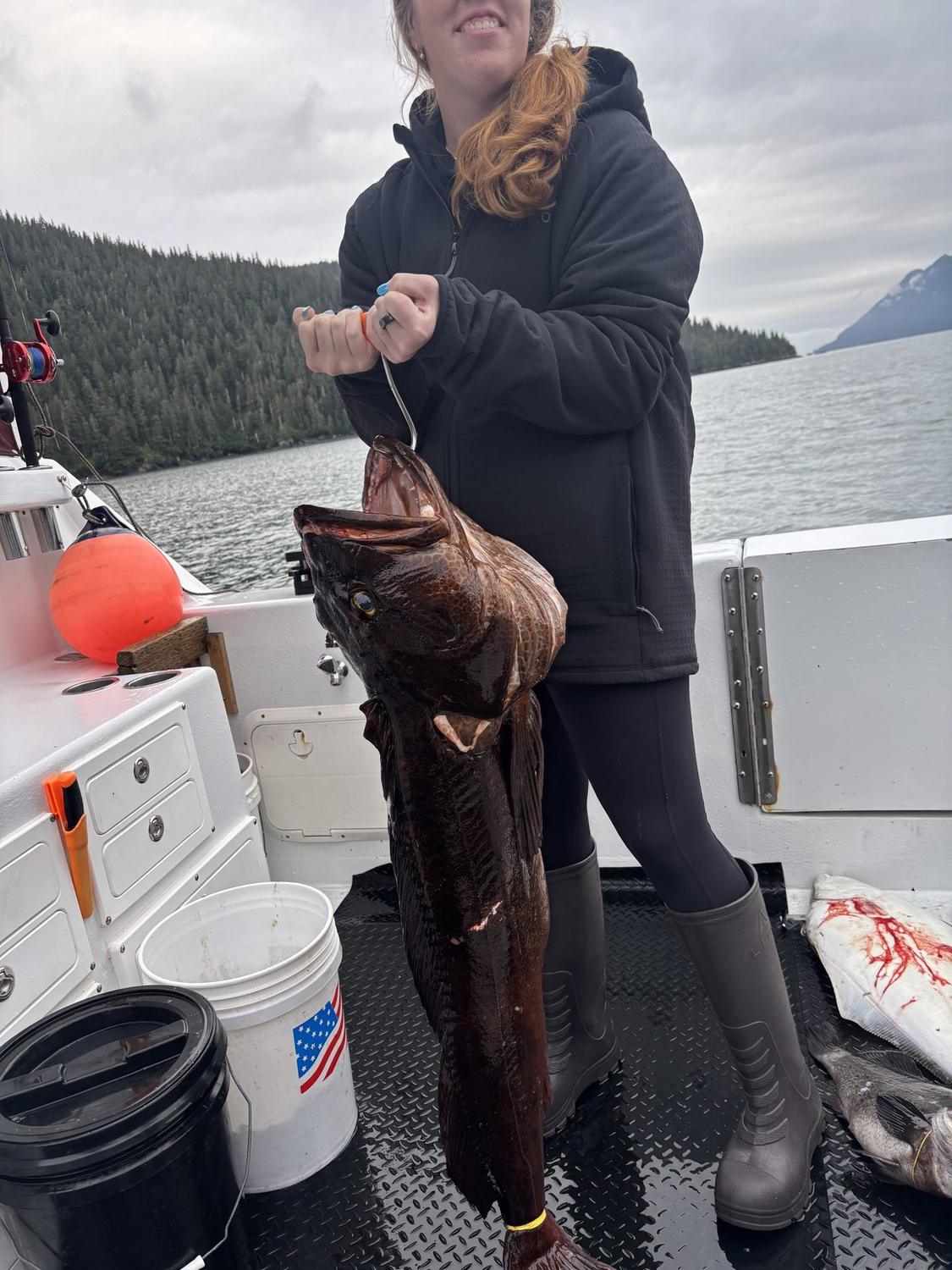 A guest with an Alaskan rockfish aboard Swoboda Charters