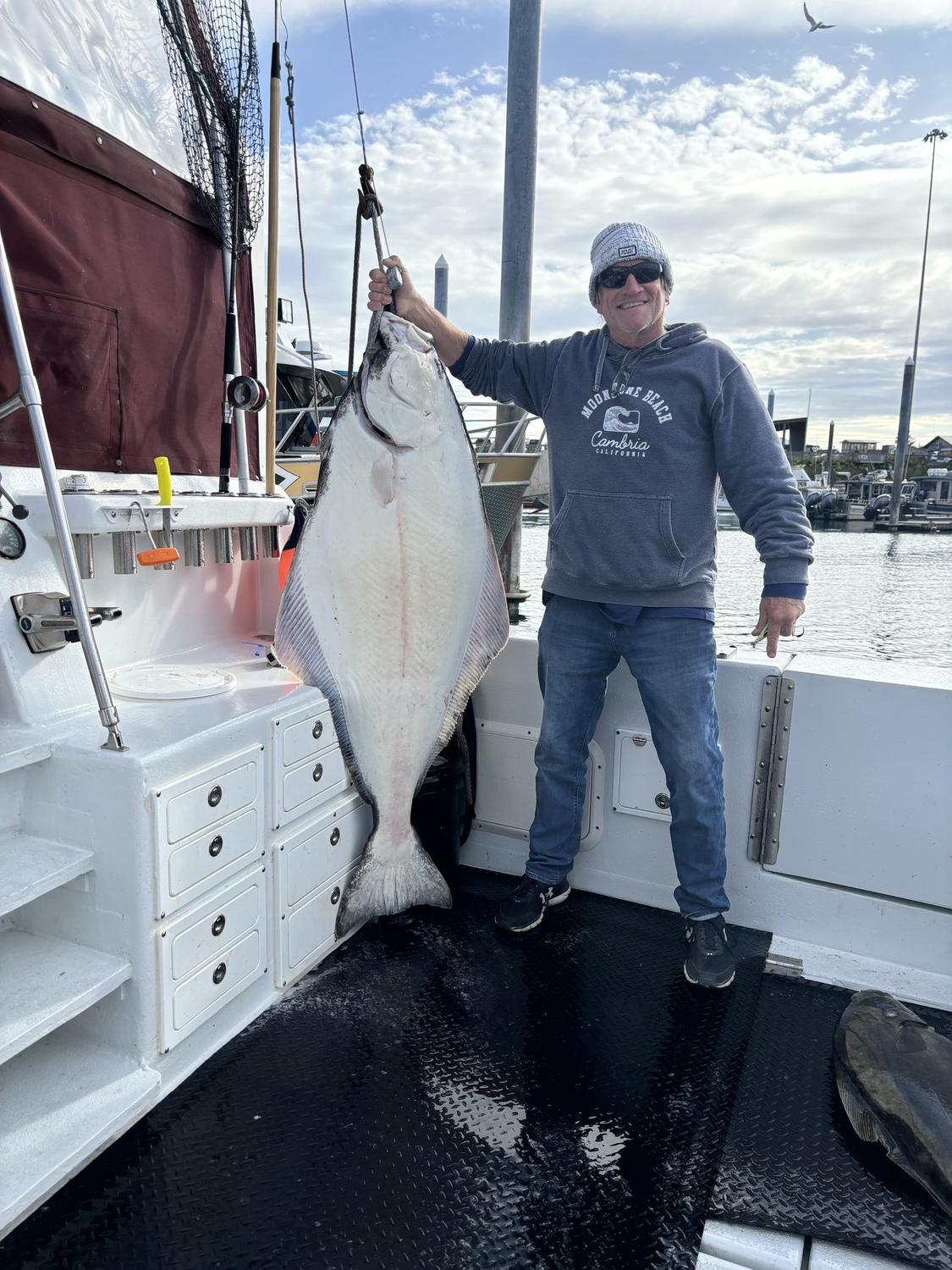Angler with a barn-door halibut at the Homer docks