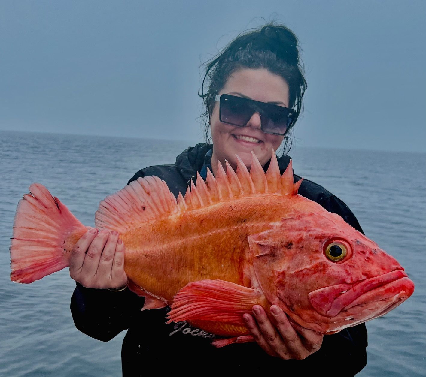 A guest with a bright Alaskan rockfish